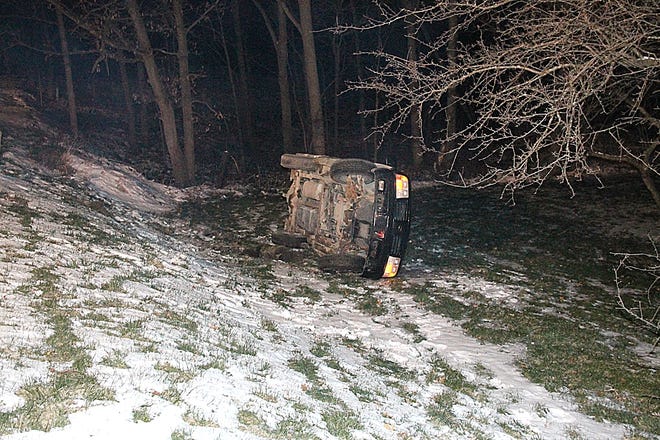 The car sits rolled on its side after veering off of Mosherville Road near Moscow Road Saturday night. COREY MURRAY PHOTO