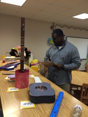 School board member Donnie Thurman Jr. judges Fallston students' instruments during Music in Our Schools. Special to The Star
