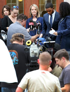 Actress Helen Hunt, CENTER, prepares to shoot a scene from the TV miniseries "Shots Fired" in front of the old Gastonia City Hall in downtown Gastonia Tuesday afternoon. JOHN CLARK/THE GAZETTE