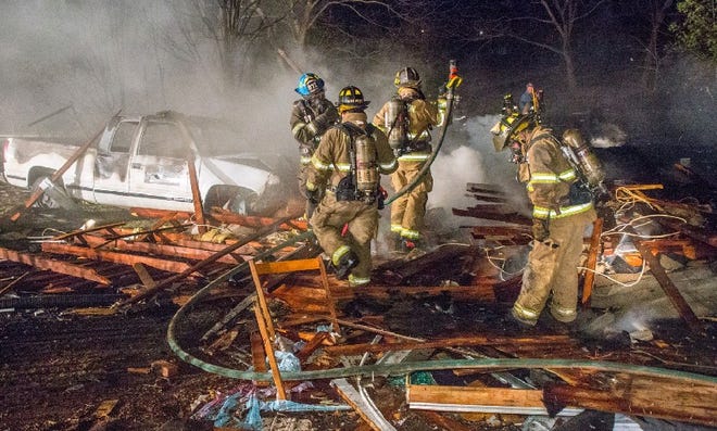 Multiple fire departments work together to put out the blaze at 909 E. Stage Coach Trail on Sunday night after the home exploded. (LemLynch photography)