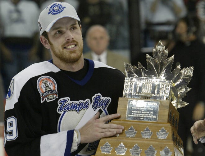 Brad Richards holds up the Conn Smythe Trophy as the Stanley Cup MVP in 2004. The Lightning won Game 7 of the Stanley Cup Finals over Calgary at the St. Petersburg Times Form in Tampa. LAKELAND LEDGER PHOTO / CALVIN KNIGHT