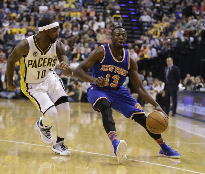 Knicks' Jerian Grant (13) goes to the basket against the Pacers' Ty Lawson during the first half of Tuesday night's game in Indianapolis. The Associated Press