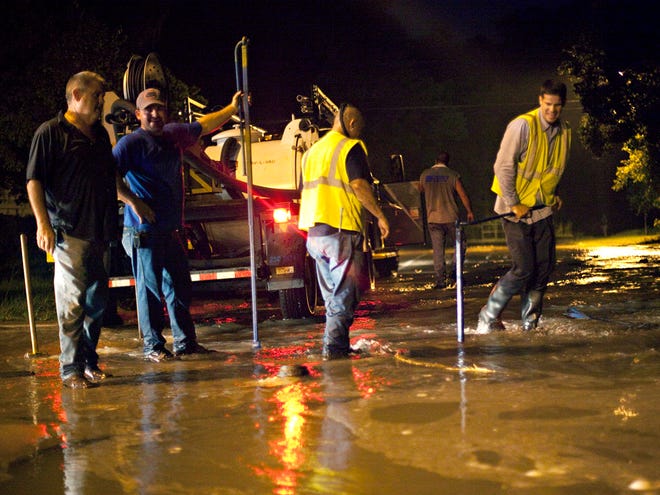 In this 2005 file photo, Gainesville Regional Utlities workers close a valve leading to a 24-inch pipe that burst at the intersection of Southwest 10th Street and Southwest 5th Avenue.