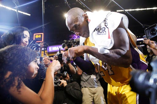 Los Angeles Lakers' Kobe Bryant, right, fist-bumps his daughter Gianna after the last NBA basketball game of his career, against the Utah Jazz on Wednesday, April 13, 2016, in Los Angeles.Bryant scored 60 points as the Lakers won 101-96.