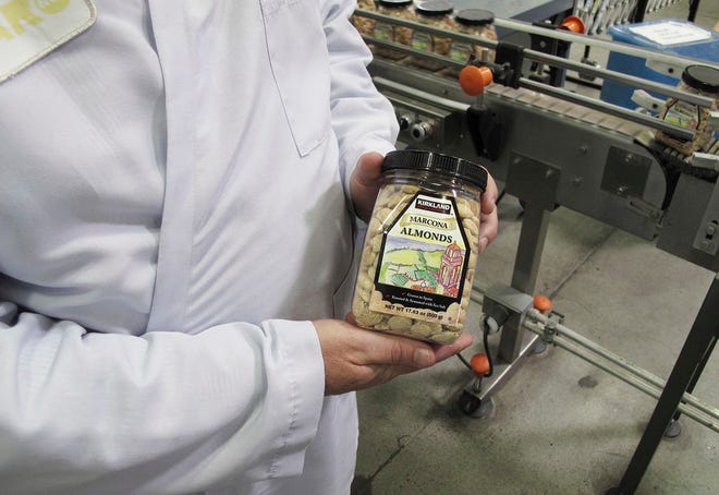 In this Monday, April 13, 2016 photo, Todd Crosswell, general manager of Caro Nut Co., holds a packaged jar of almonds at the company's nut processing plant in Fresno, Calif. Sophisticated thieves last year stole six truckloads from Caro Nut last year at a loss of $1.2 million to the firm. The scheme has cost the California nut industry nearly $7.6 million dollars in the last four years. In some cases, the thieves with international ties use fake shipping papers to assume the identity of legitimate firms to steal truckloads worth between $150,000 and $500,000 each. (AP Photo/Scott Smith)