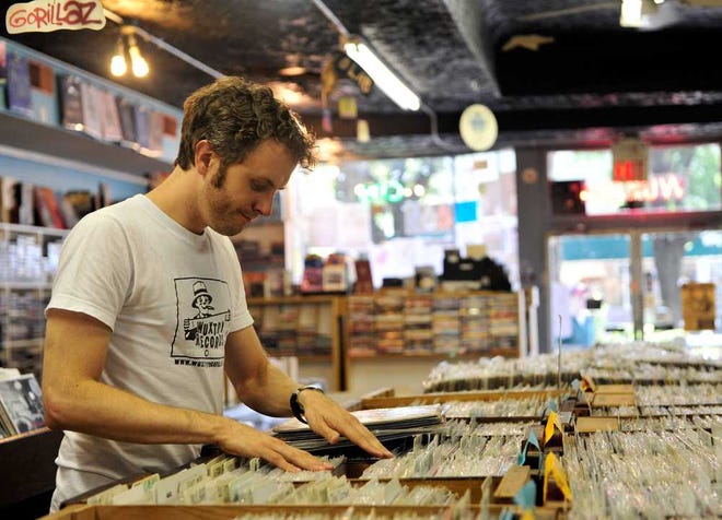 Robert Brown organizes records at Wuxtry Records in downtown Athens. (Richard Hamm/Staff/richard.hamm@onlineathens.com)