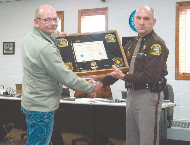 Cheboygan County Sheriff Dale Clarmont presents retiring Deputy Patrick Charboneau with a shadow box containing his certificate of retirement and other work memorabilia on behalf of the Cheboygan County Deputies Association. Charboneau has served the citizens of Cheboygan County for more than 32 years.