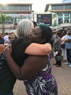 Paula.Horvath@jacksonville.com Women embrace during a special event Monday to remember victims of violence to kick off Crime Victims' Rights Week. The remembrance of slain loved ones was organized by the Justice Coalition.