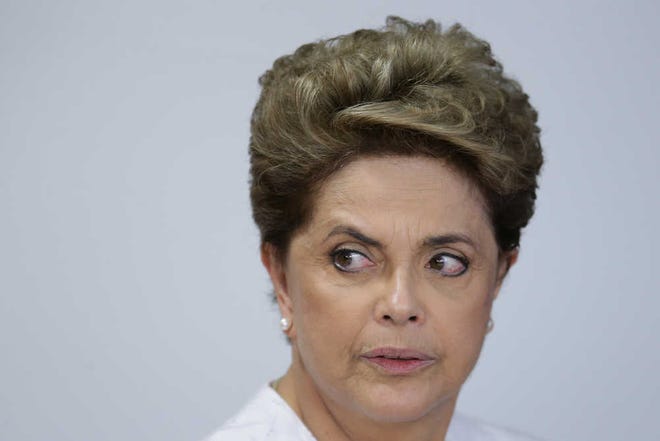 Brazil's President Dilma Rousseff arrives for a meeting on state land issues, at Planalto presidential palace in Brasilia, Brazil, Friday, April 15, 2016. The lower chamber of Brazil's Congress began a debate on whether to impeach Rousseff, a question that underscores deep polarization in Latin America's largest country and most powerful economy. The crucial vote is slated for Sunday. (AP Photo/Eraldo Peres)
