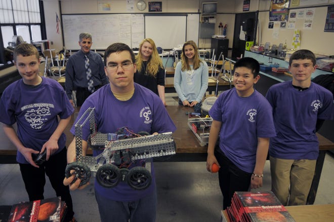 Burncoat Middle School robotics squad is bound for a world meet in Kentucky. From left, Colin Scuderi, 13, Ryan Smith, 15, Bromly Domingo, 13, and Jake Shamaly, 13. In background are teacher Steve Rapa, Kathryn Quinn, 13, and Alyssa Betancourt, 12. T&G Staff/Christine Peterson