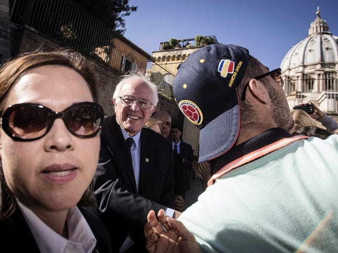 US presidential candidate Bernie Sanders meets supporters outside the Perugino gate at the Vatican on Friday.