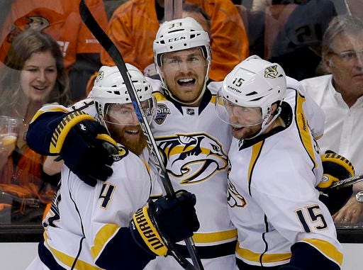 Nashville Predators center Colin Wilson, middle, celebrates with defenseman Ryan Ellis, left, and center Craig Smith after Wilson scored during the second period of Game 1 in an NHL hockey Stanley Cup playoffs first-round series against the Anaheim Ducks in Anaheim, Calif., Friday, April 15, 2016. (AP Photo/Chris Carlson)