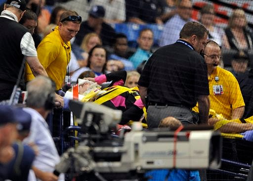 Medical personnel carry a fan from the stands by stretcher after she was hit a foul ball from Tampa Bay Rays designated hitter Steven Souza Jr. during the seventh inning of a baseball game against the Chicago White Sox, Friday, April 15, 2016, in St. Petersburg, Fla. (AP Photo/Steve Nesius)