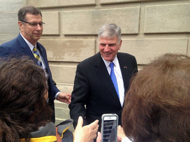 Gov. Phil Bryant greets an attendee at a Wednesday prayer rally by evangelist Franklin Graham at the state Capitol in Jackson, Miss., Wednesday, April 13, 2016. (AP Photo/Jeff Amy)