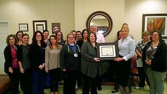 — Courtesy photo 

Fountain View of Monroe social worker Amanda Kettinger (left) receives the 2016 Great Lakes Caring Home Health and Hospice Essential Piece Award from patient care coordinator Sandra Robbins. They are pictured with the Fountain View of Monroe management staff.