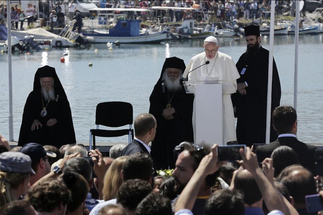 Pope Francis delivers his speech at the Mytilene port on the Greek island of Lesbos, Saturday, April 16, 2016. The heads of the Catholic and Orthodox churches have conducted a prayer ceremony for refugees at the port of Mytilene, the capital of the Greek island of Lesbos where hundreds of thousands of have passed through on perilous journeys from the Turkish coast toward Europe. (AP Photo/Petros Giannakouris)