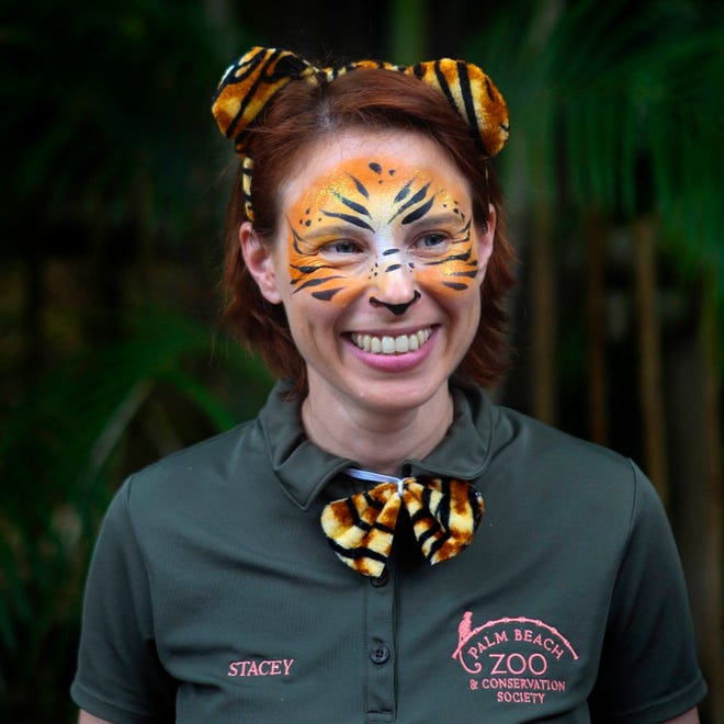 In this March 7, 2015 photo, Stacey Konwiser smiles during the dedication of the new tiger habitat at the Palm Beach Zoo in West Palm Beach, Fla. Stacey Konwiser, 38, was attacked and killed by a 13-year-old male tiger in an enclosure known as the night house that is not visible to the public, Palm Beach Zoo spokeswoman Naki Carter said. It's where the tigers sleep and are fed. (Brianna Soukup/Palm Beach Post via AP)