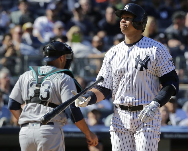 Yankees' Alex Rodriguez flips his bat after striking out during the sixth inning of Saturday's game against the Seattle Mariners at the Stadium. Rodriguez struck out three times in the game and is hitless in his last 19 at-bats. The Associated Press