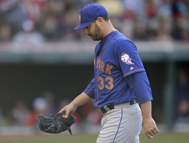 Mets starting pitcher Matt Harvey walks to the dugout after being removed in the sixth inning of Saturday's game against the Indians in Cleveland. Harvey was charged with five runs as his record dropped to 0-3. The Associated Press