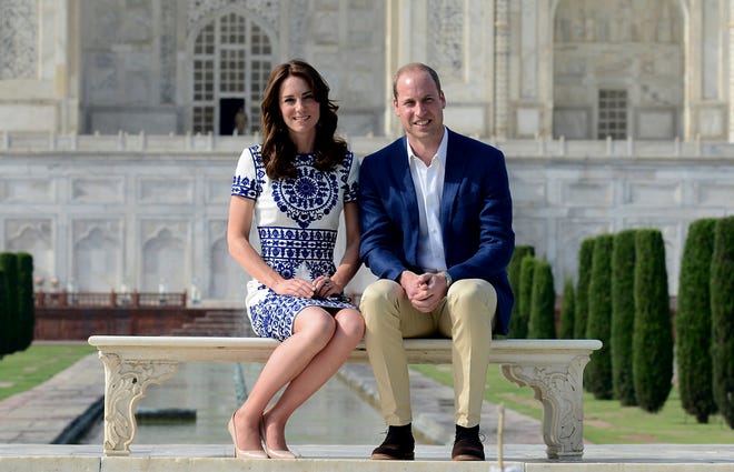 Britain's Prince William, along with his wife, Kate, the Duchess of Cambridge, pose in front of the Taj Mahal in Agra, India, Saturday, April 16, 2016. Agra is the last stop on the royal couple's weeklong visit to India and neighboring Bhutan. (Money Sharma/ Pool photo via AP)