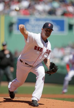 Boston Red Sox starter Steven Wright delivers a pitch against the Toronto Blue Jays in the first inning of a baseball game at Fenway Park, Sunday, April 17, 2016, in Boston.