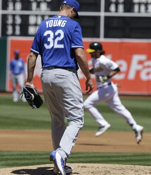 Royals starting pitcher Chris Young yields a three-run homer to A’s slugger Josh Reddick in the first inning.