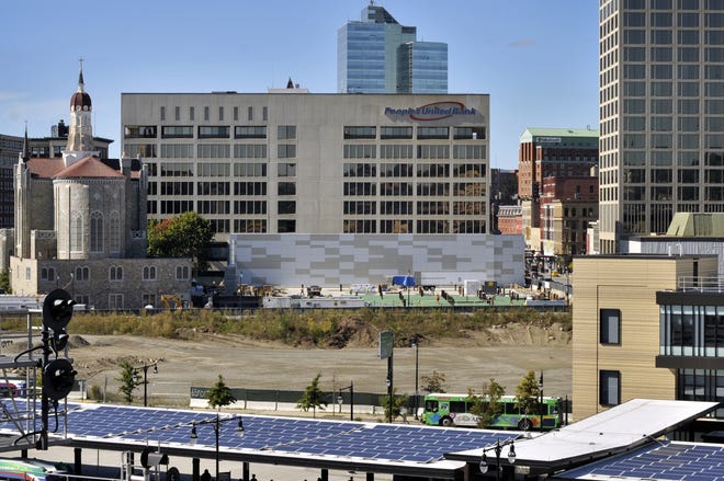 Construction of a hotel and underground parking garage for the CitySquare project continues next to the People's United Bank building, center, and the former Notre Dame des Canadiens Church, left, on Front Street in Worcester. T&G File Photo/Paul Kapteyn