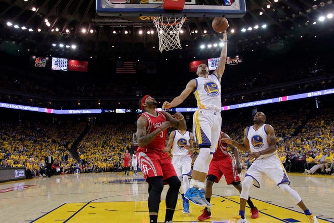 Golden State Warriors' Stephen Curry (30) goes for a layup during Game 1 of a first-round playoff series against the Houston Rockets on Saturday in Oakland, Calif.