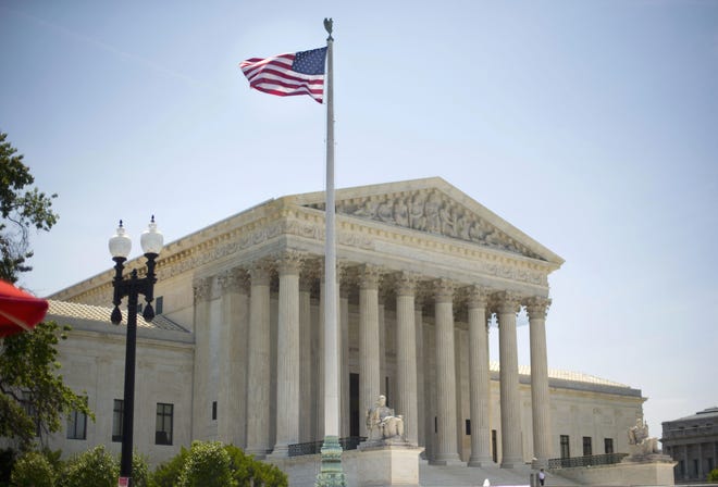 In this June 30, 2014 file photo, the Supreme Court building in Washington. The Supreme Court is taking up an important dispute over immigration that could affect millions of people who are living in the country illegally. The Obama administration is asking the justices in arguments Monday, April 18, 2016, to allow it to put in place two programs that could shield roughly 4 million people from deportation and make them eligible to hold a job in the U.S. (AP Photo/Pablo Martinez Monsivais)