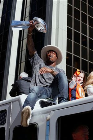 FILE - In this Tuesday, Feb. 9, 2016 file photo, Denver Broncos Super Bowl MVP defensive back Von Miller hoists the Lombardi Trophy high for the fans to see during a Super Bowl victory parade in Denver. The Super Bowl champions reconvened Monday, April 18, minus some notable star power. Miller is in California doing the jive with Lindsay Arnold on ABC's "Dancing With the Stars." (AP Photo/Jack Dempsey, File)