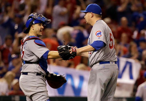 Chicago Cubs relief pitcher Trevor Cahill, right, and catcher Miguel Montero celebrate winning a baseball game against the St. Louis Cardinals on Monday, April 18, 2016, in St. Louis. The Cubs won 5-0. (AP Photo/Jeff Roberson)