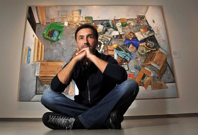 Amer Kobaslija, a Bosnian refugee who came to Jacksonville with his parents in 1997, is pictured in front of his painting, "Sputnik Sweetheart of New Orleans and the End of the World," part of his "Sense of Place" exhibit in the UNF Gallery at the Museum of Contemporary Art Jacksonville.   Bruce.Lipsky@jacksonville.com