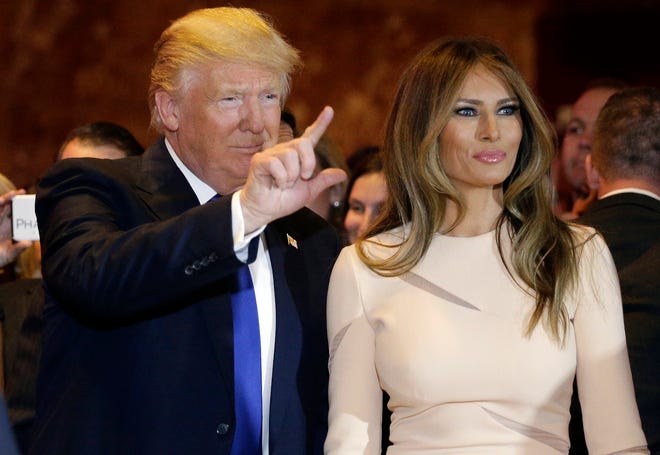 Republican presidential candidate Donald Trump, left, waves as he stands with his wife Melania Trump before speaking at a New York primary night campaign event, Tuesday, April 19, 2016, in New York. (AP Photo/Julie Jacobson)