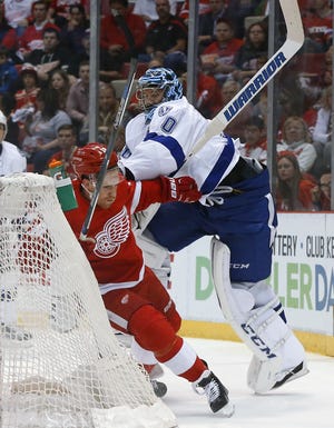 Tampa Bay Lightning goalie Ben Bishop (30) checks Detroit Red Wings center Joakim Andersson during the first period of Game 4 in a first-round NHL hockey Stanley Cup playoff series, Tuesday, April 19, 2016, in Detroit. (AP Photo/Paul Sancya)