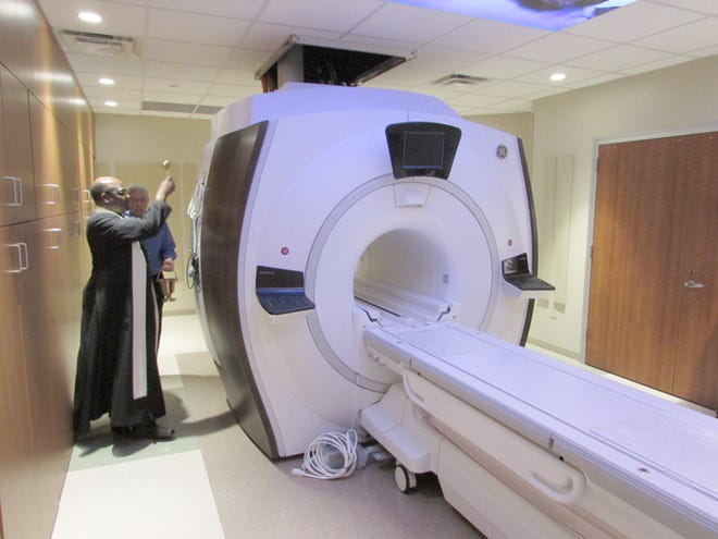 Rev. Johndamseni Zilimu of Visitation Catholic Church conducted a blessing Tuesday of the new MRI machine at OSF Saint Luke Medical Center in Kewanee.