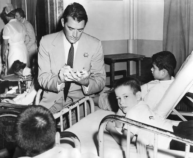 Actor Gregory Peck signs "Moby-Dick" comics for patients at Sol-E-Mar Children's Hospital in Dartmouth. PHOTOS COURTESY OF SPINNER PUBLICATIONS