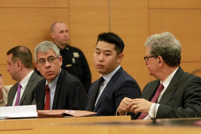 Former NYPD officer Peter Liang, center, was spared prison time on Tuesday in the accidental shooting death of an unarmed man, Akai Gurley, in a darkened stairwell. The judge also reduced his manslaughter conviction to a lesser charge. THE ASSOCIATED PRESS