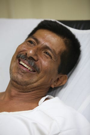 Earthquake survivor Pablo Rafael Cordova Canizares smiles as he rests at the Verdi Cevallos Balda hospital in Portoviejo, Ecuador, Monday, April 18, 2016. Cordova's wife had given up on ever seeing him again after the five-story Gato de Portoviejo hotel collapsed on him Saturday, pancaked by the magnitude-7.8 earthquake like the rest of downtown. (AP Photo/Emilio D. Garcia)