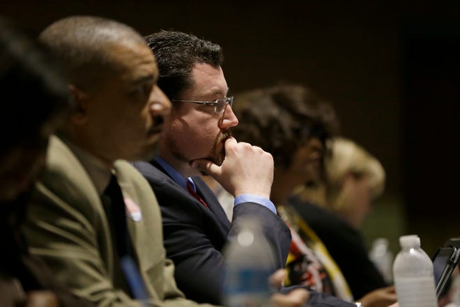 FILE - In this March 15, 2016 file photo, Ferguson Mayor James Knowles III listens during a city council meeting in Ferguson, Mo. St. Louis-area residents were sounding off Tuesday, April 19, 2016 in the last public hearing on the U.S. Department of Justice's settlement that calls for sweeping changes in Ferguson, where 18-year-old Michael Brown was fatally shot by a police officer. (AP Photo/Jeff Roberson File)