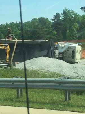 Gravel from an overturned truck is cleaned up on the I-20 on ramp off of Lewiston Road near Grovetown.