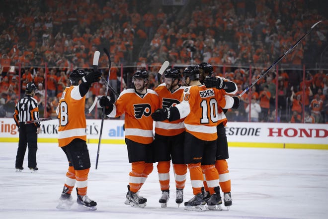 The Flyers' Claude Giroux (28) celebrates with teammates after Andrew MacDonald's (47) goal in the second period during Game 4 against the Washington Capitals on Wednesday, April 20, 2016, in Philadelphia.
