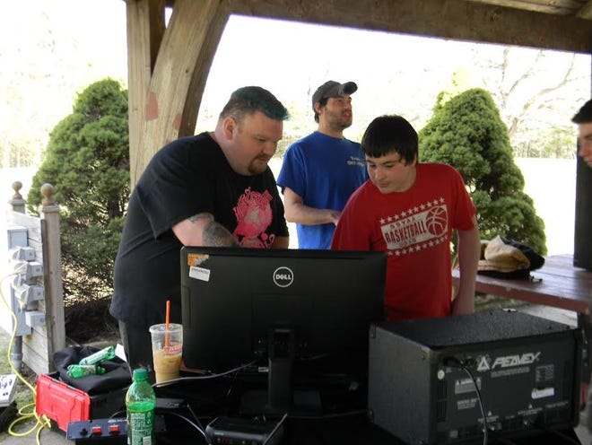 DJ Bobby G discusses song requests with a teen who was enjoying the music at Gowen Park last Wednesday, April 13. PHOTO BY ELLEN W. TODD
