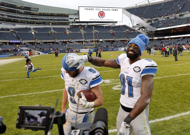 FILE - In this Jan. 3, 2016, file photo, Detroit Lions wide receiver Calvin Johnson (81) clowns around with quarterback Matthew Stafford (9) as they walk off the field after an NFL football game against the Chicago Bears in Chicago. The Lions have kicked off their first series of offseason workouts on Tuesday, April 19, 2016, under first-year general manager Bob Quinn and without Johnson, who Stafford thought might be playing his last game on Jan. 3 at Chicago. (AP Photo/Charles Rex Arbogast, File0