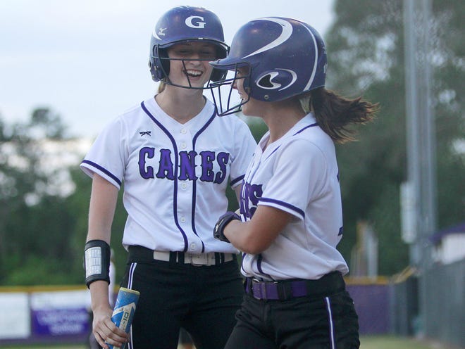 Gainesville Hurricanes baserunner Savannah Law, right, celebrates with batter Katie Chronister after scoring a run against Jacksonville Creekside during the Region 1-7A quarterfinals on Wednesday. The Hurricanes won 3-0 and will host Columbia in the regional semifinals on Tuesday.