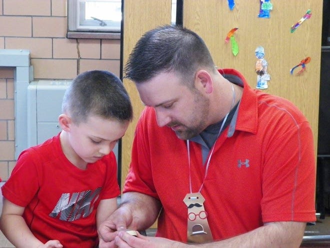 Cuyler Long and his father engage in activities at Immaculate Conception School’s father celebration. PHOTO PROVIDED