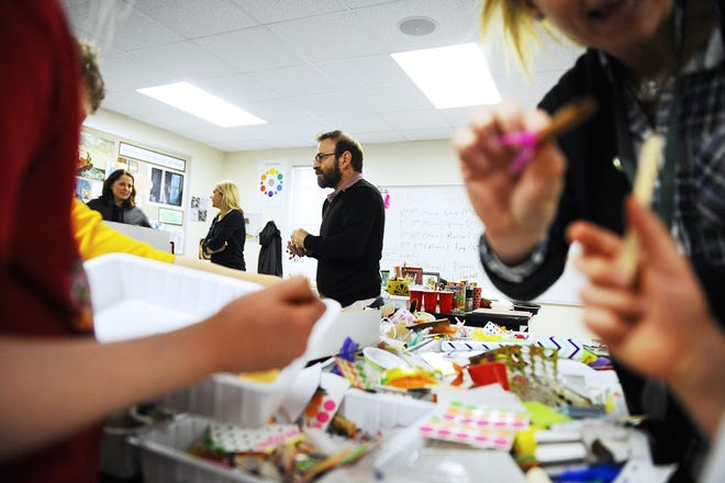 Israeli mixed-media artist Hanoch Piven (who has done covers for Time, Newsweek and others) provides instructions to students as they work on creating self-portraits made out of found objects. 

(Wicked Local Staff Photo/Brett Crawford)