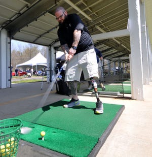 Jeff Hall, 41, of Mount Holly, hits a golf ball during an amputee veterans golf event at Indian Springs Country Club in Evesham on Thursday, April 21, 2016.