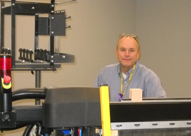 Steve Brown in 2012, with a Picanol Summum airjet weaving machine at the Picanol showroom in Greenville, S.C. Photo courtesy of Gaston College.