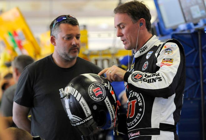 Kevin Harvick, right, talks with Tony Stewart during NASCAR Sprint Cup Series auto race practice at Texas Motor Speedway in Fort Worth, Texas, Thursday, April 7, 2016. The annual Duck Commander 500 runs Saturday night.