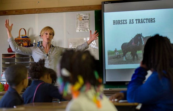 Peoria Farm Bureau Ag in the Classroom director Abbie Enlund talks to third grade students at Woodrow Wilson School about the history of the horse during a recent presentation.